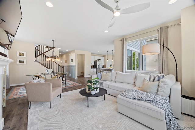 8261 Garden City Ave, Littleton, CO 80125 - living room with stairs, wood finished floors, recessed lighting, ceiling fan, and baseboards