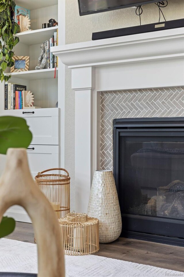 8261 Garden City Ave, Littleton, CO 80125 - detailed view of wood finished floors and a fireplace