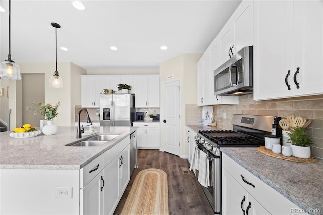 8261 Garden City Ave, Littleton, CO 80125 - kitchen featuring stainless steel appliances, a sink, white cabinets, dark wood-style floors, and recessed lighting