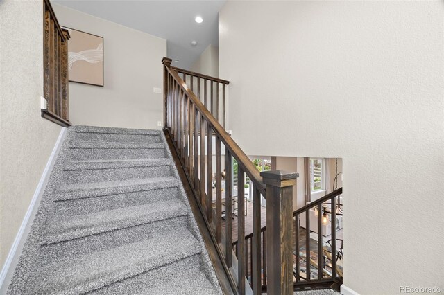 8261 Garden City Ave, Littleton, CO 80125 - stairway with a textured wall and baseboards