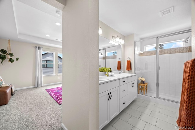8261 Garden City Ave, Littleton, CO 80125 - bathroom featuring a stall shower, double vanity, and recessed lighting