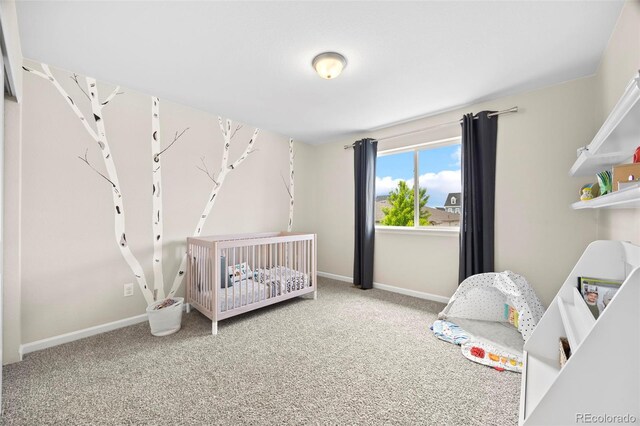 8261 Garden City Ave, Littleton, CO 80125 - carpeted bedroom featuring baseboards and a crib