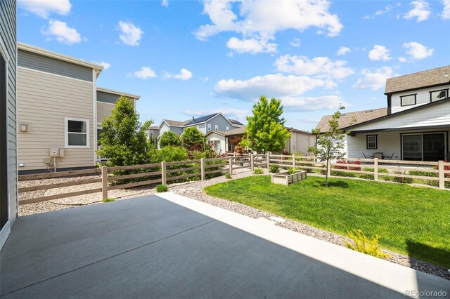 8261 Garden City Ave, Littleton, CO 80125 - view of patio / terrace with a vegetable garden and a residential view