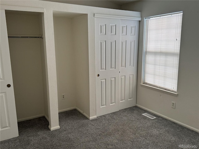 unfurnished bedroom featuring dark colored carpet