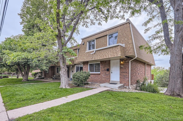 5712 S Lowell Blvd, Littleton, CO 80123 - view of front property with brick siding, a front lawn, mansard roof, and roof with shingles