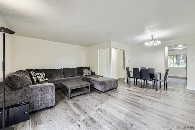 5712 S Lowell Blvd, Littleton, CO 80123 - living area featuring a chandelier, light wood finished floors, and baseboards