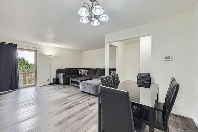 5712 S Lowell Blvd, Littleton, CO 80123 - dining area with wood finished floors, a chandelier, and baseboards