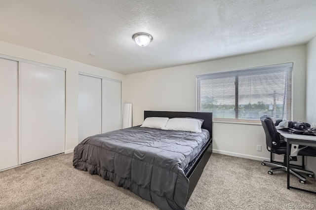 5712 S Lowell Blvd, Littleton, CO 80123 - bedroom with carpet floors, a textured ceiling, two closets, baseboards, and a desk
