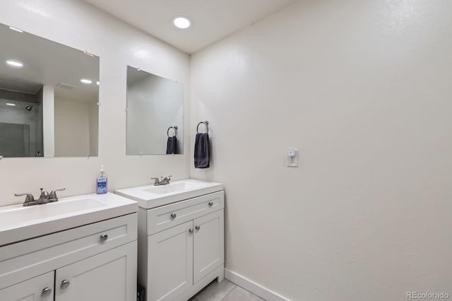 5712 S Lowell Blvd, Littleton, CO 80123 - full bathroom featuring two vanities, baseboards, tile patterned floors, and recessed lighting
