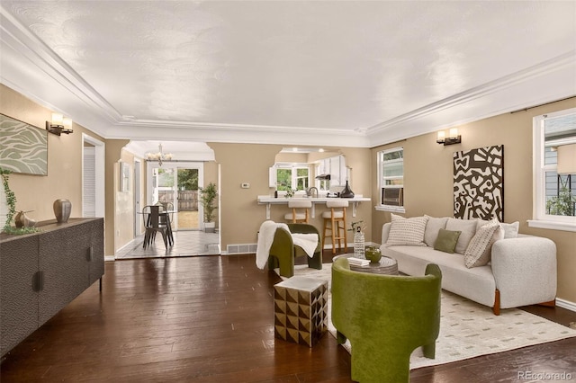 3979 S Grant St, Englewood, CO 80113 - living area with plenty of natural light, crown molding, hardwood / wood-style flooring, and a chandelier
