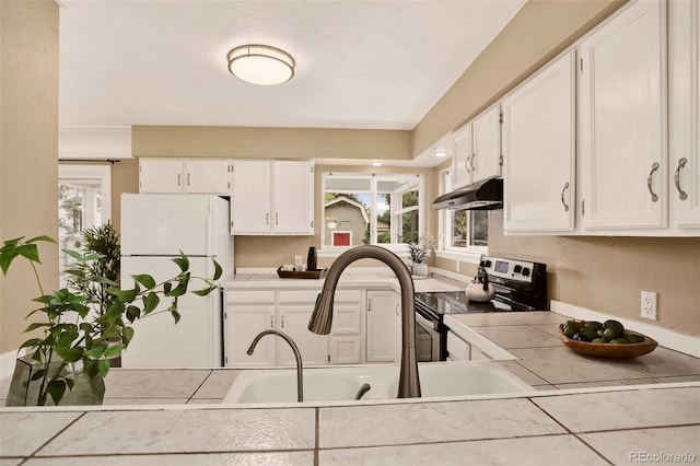 3979 S Grant St, Englewood, CO 80113 - kitchen featuring freestanding refrigerator, electric range, under cabinet range hood, tile counters, and white cabinets
