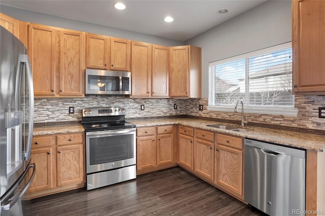 kitchen with backsplash, dark hardwood / wood-style flooring, sink, and appliances with stainless steel finishes