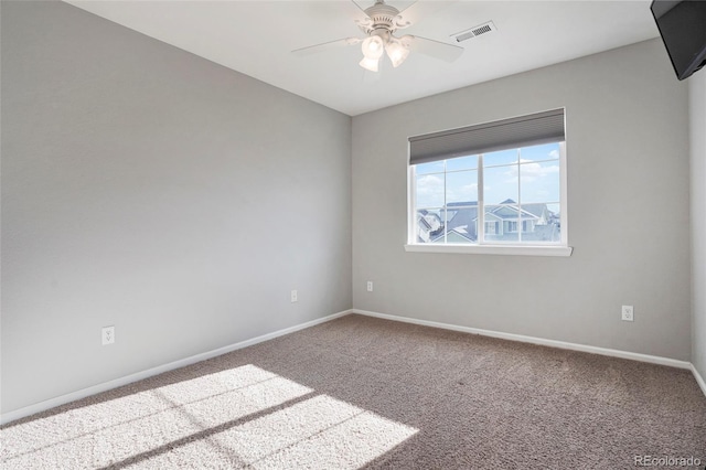 carpeted spare room with ceiling fan