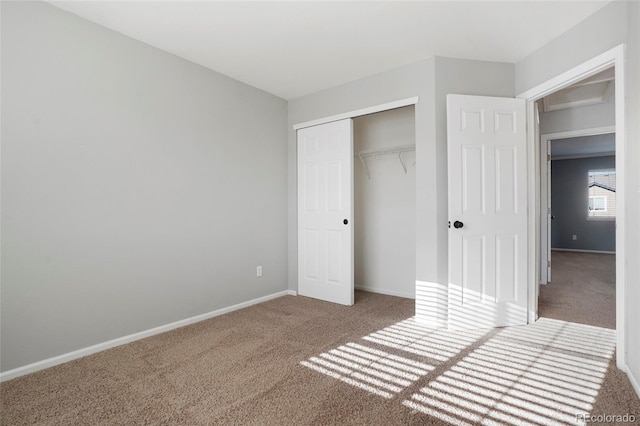 unfurnished bedroom with carpet floors and a closet