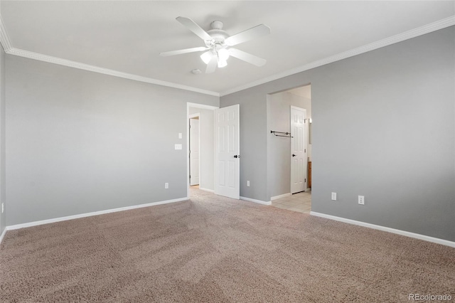 spare room featuring ceiling fan, crown molding, and light carpet