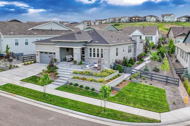 2159 Bellcove Dr, Castle Pines, CO 80108 - view of front of home with a residential view, driveway, a garden, and stone siding