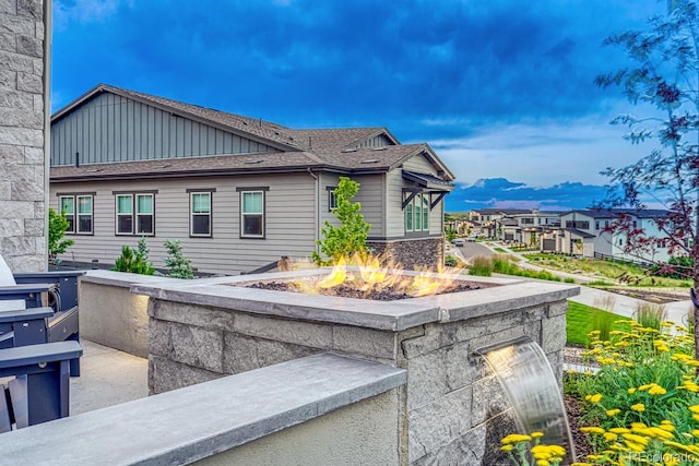 2159 Bellcove Dr, Castle Pines, CO 80108 - view of home's exterior featuring an outdoor fire pit and board and batten siding