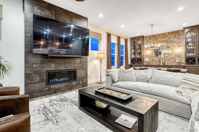 2159 Bellcove Dr, Castle Pines, CO 80108 - living area with built in shelves, a fireplace, recessed lighting, and a chandelier