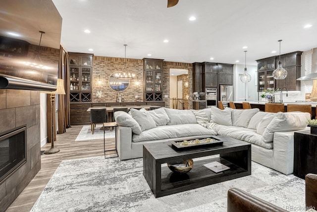 2159 Bellcove Dr, Castle Pines, CO 80108 - living area with recessed lighting, a tile fireplace, and light wood-style floors