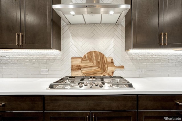 2159 Bellcove Dr, Castle Pines, CO 80108 - kitchen featuring range hood, stainless steel gas cooktop, tasteful backsplash, and dark brown cabinetry