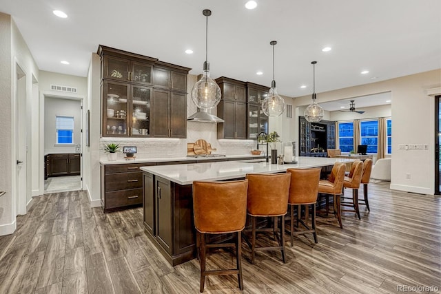 2159 Bellcove Dr, Castle Pines, CO 80108 - bar with wood finished floors, a ceiling fan, backsplash, decorative light fixtures, and recessed lighting