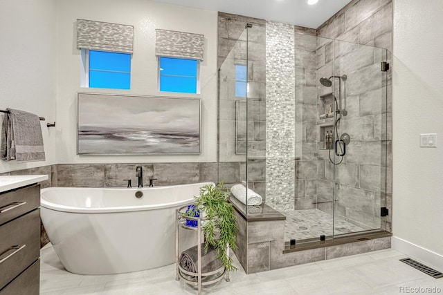 2159 Bellcove Dr, Castle Pines, CO 80108 - bathroom featuring a freestanding tub, a stall shower, vanity, and tile walls