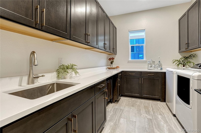2159 Bellcove Dr, Castle Pines, CO 80108 - laundry area with cabinet space, independent washer and dryer, and light wood-style floors