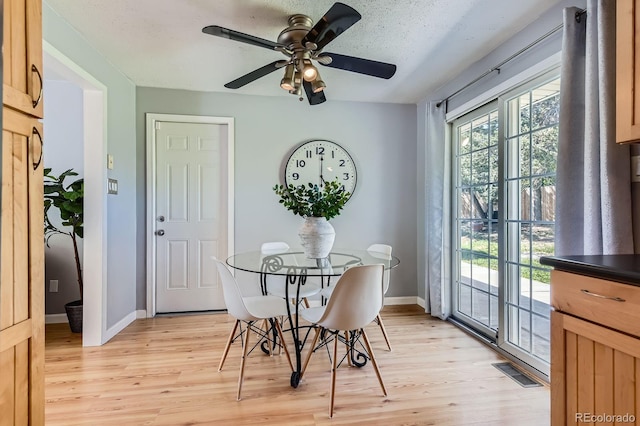 13483 Achilles Dr, Lone Tree, CO 80124 - dining space featuring light wood-style floors, a ceiling fan, and a textured ceiling