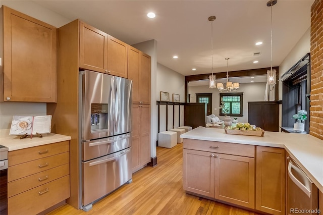 3525 N Alcott St, Denver, CO 80211 - kitchen featuring stainless steel appliances, light wood finished floors, open floor plan, light countertops, and a chandelier