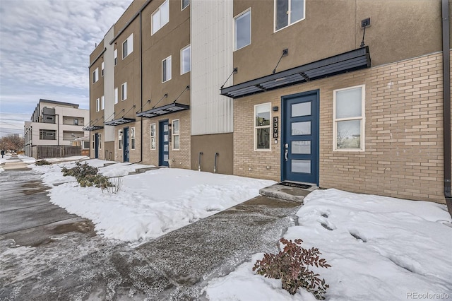 view of snow covered property entrance