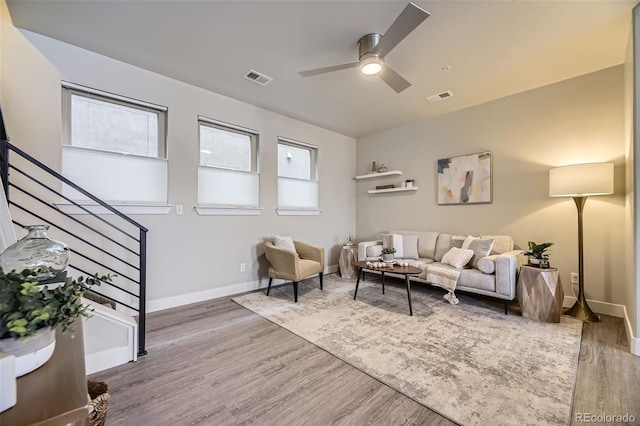 living room featuring hardwood / wood-style flooring, a wealth of natural light, and ceiling fan