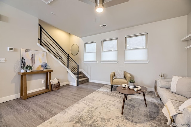 living room with hardwood / wood-style flooring and ceiling fan