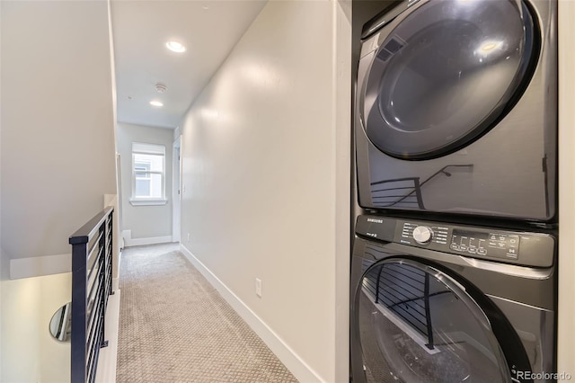 washroom with light colored carpet and stacked washer and clothes dryer