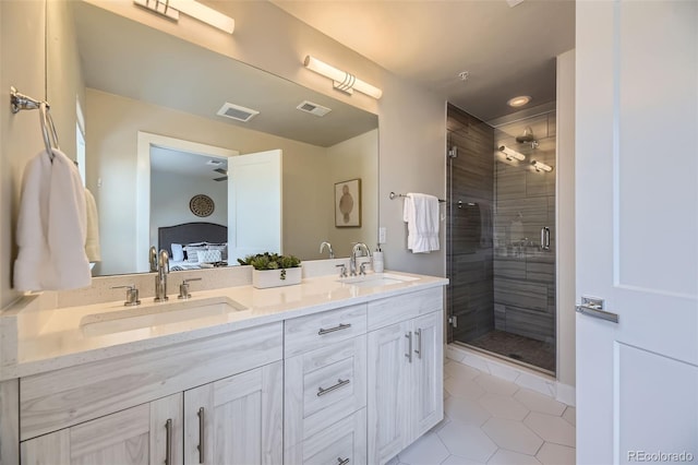 bathroom featuring vanity, a shower with shower door, and tile patterned floors