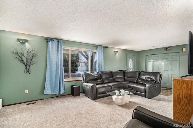 living room with carpet floors and a textured ceiling