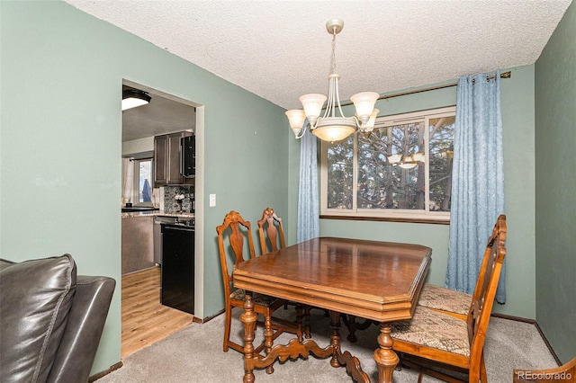 dining space with light carpet, a textured ceiling, and a chandelier