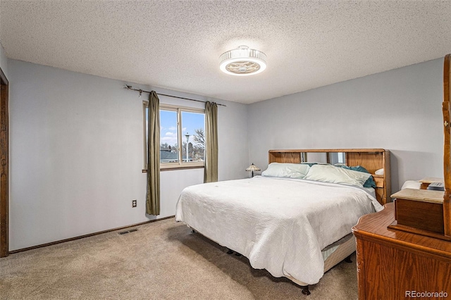 carpeted bedroom featuring a textured ceiling