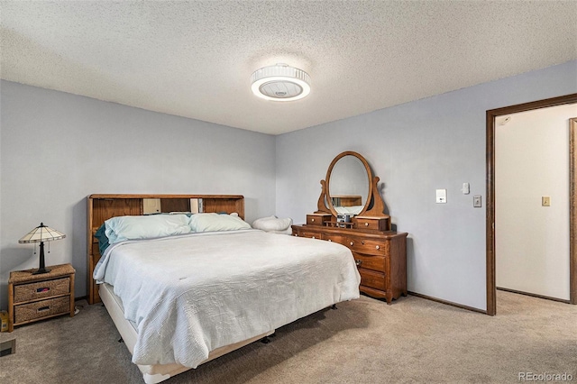 bedroom with carpet and a textured ceiling