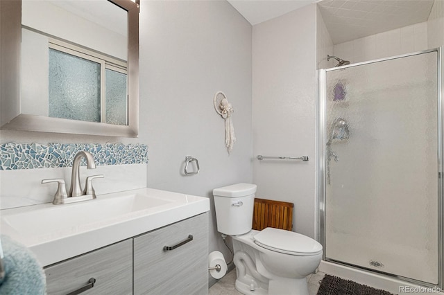 bathroom with vanity, a shower with shower door, and toilet