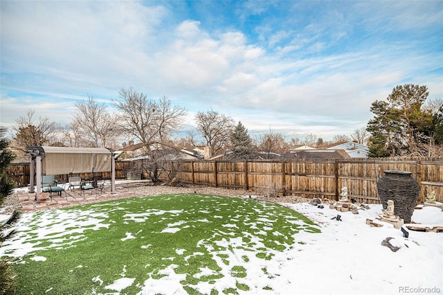 yard covered in snow with a patio