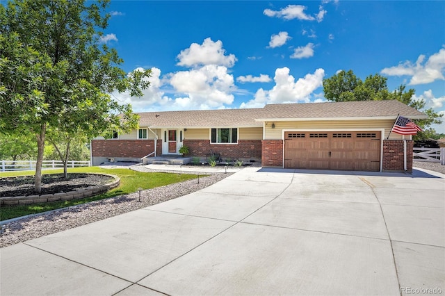 9880 E 157th Ave, Brighton, CO 80602 - ranch-style home with brick siding, concrete driveway, and an attached garage