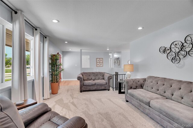 9880 E 157th Ave, Brighton, CO 80602 - carpeted living area featuring recessed lighting and a textured ceiling