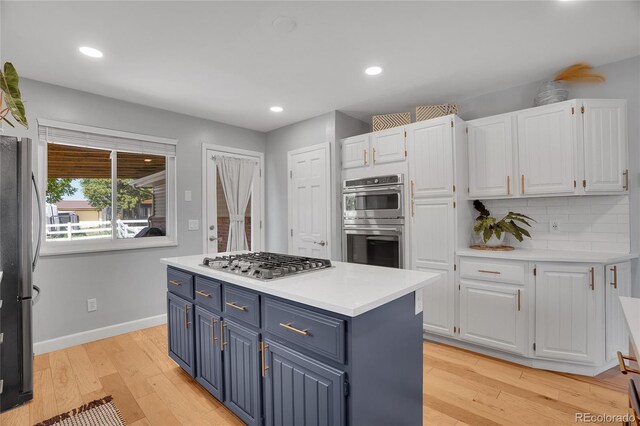 9880 E 157th Ave, Brighton, CO 80602 - kitchen featuring blue cabinetry, stainless steel appliances, white cabinets, light countertops, and recessed lighting