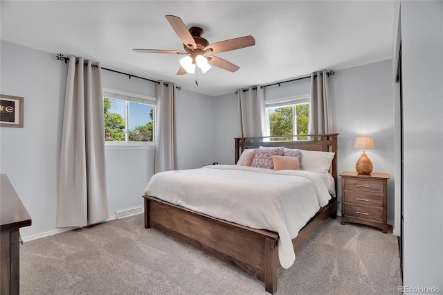9880 E 157th Ave, Brighton, CO 80602 - bedroom with multiple windows, light carpet, ceiling fan, and baseboards