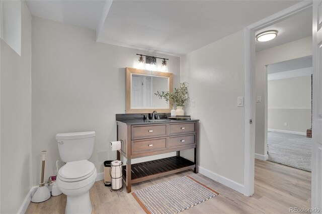 9880 E 157th Ave, Brighton, CO 80602 - bathroom with wood finished floors, vanity, toilet, and baseboards