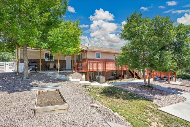 9880 E 157th Ave, Brighton, CO 80602 - back of house featuring a patio, brick siding, stairway, a wooden deck, and central AC unit
