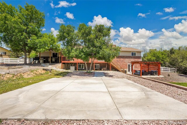 9880 E 157th Ave, Brighton, CO 80602 - view of front of house featuring a patio area, brick siding, stairway, and a pergola