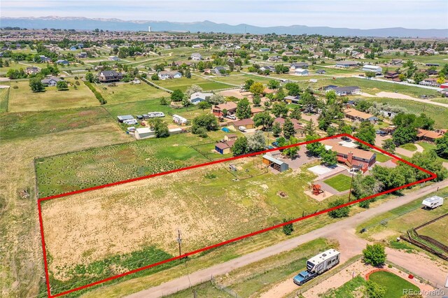 9880 E 157th Ave, Brighton, CO 80602 - aerial perspective of suburban area featuring property parcel outlined and mountains