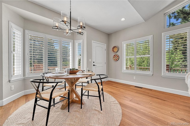 dining room featuring baseboards, a chandelier, light wood-style flooring, and recessed lighting