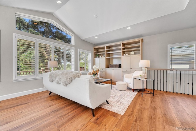 living area with light wood-style flooring, baseboards, recessed lighting, and high vaulted ceiling